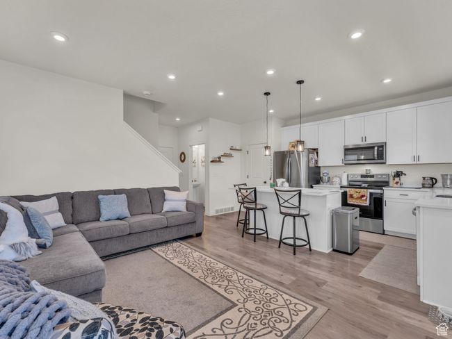 Living room featuring light wood-type flooring and recessed lighting | Image 5