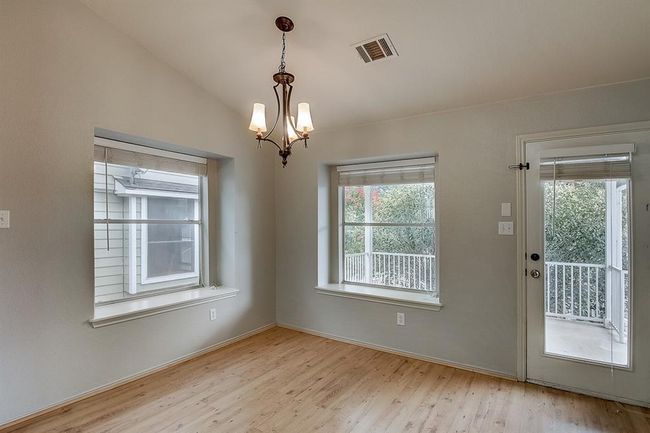Unfurnished dining area with plenty of natural light, wood finished floors, a chandelier, and baseboards | Image 27