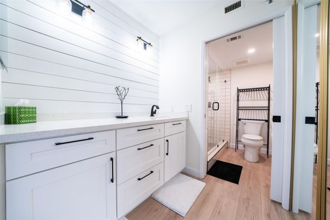 Primary dressing area leading into walk-in closet and bathroom | Image 11