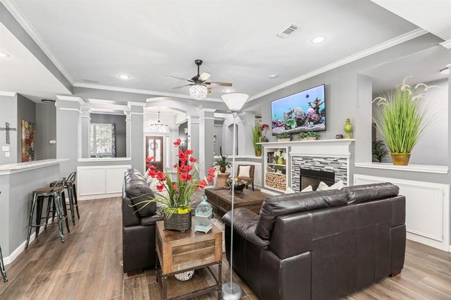 The family room is open to the kitchen and offers a comfortable space for family and friends. | Image 14