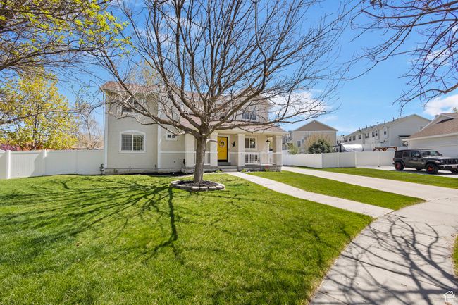 View of front of home with stucco siding, a front lawn, a porch, and fence private yard | Image 4
