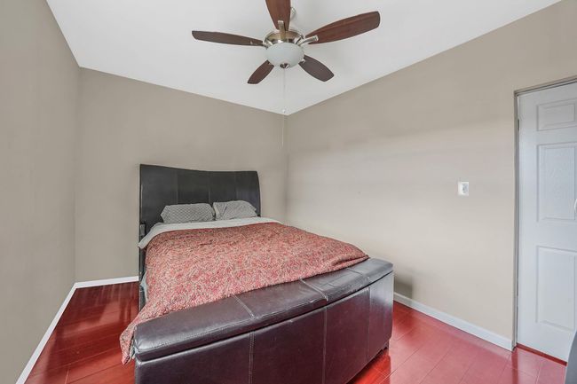 Bedroom with wood finished floors, baseboards, and ceiling fan | Image 20