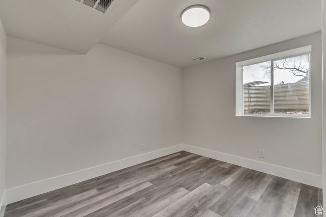 Spare room featuring visible vents, baseboards, and wood finished floors | Image 18