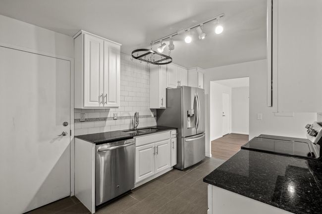 The kitchen entrance to this home is seen here. | Image 11