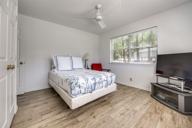 Downstairs Bedroom featuring wood finished floors, and a ceiling fan | Image 14