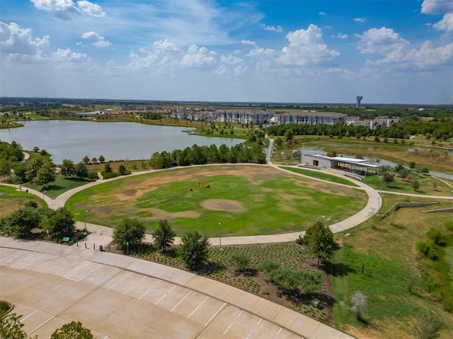 Features a single-family home with a spacious yard in Bridgeland, a master-planned community offering lakes, pools, sidewalks, and green spaces. | Image 32