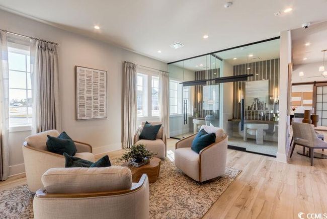 Living room with light wood finished floors, recessed lighting, baseboards, and a wealth of natural light | Image 23