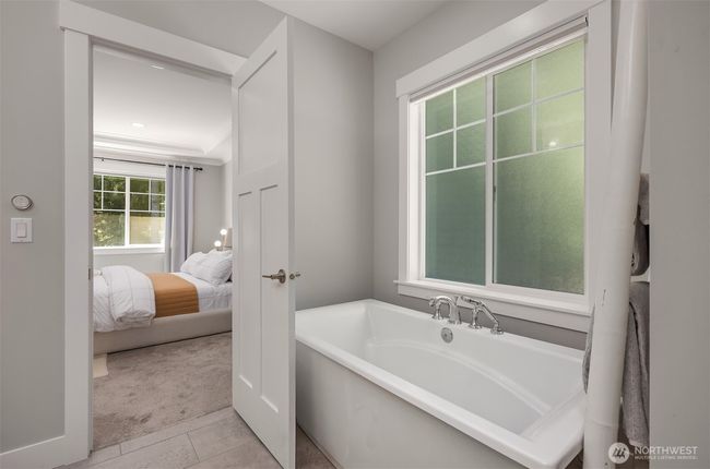 Relax in your soaking tub letting in natural light through the privacy window. | Image 20