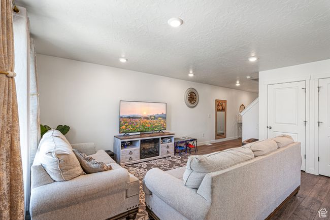 Living area featuring dark wood finished floors, recessed lighting, and baseboards | Image 8