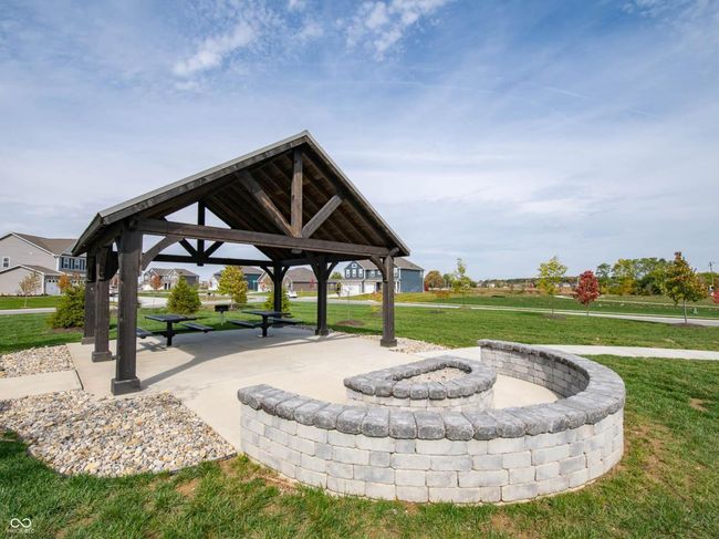 surrounding community featuring a gazebo, a fire pit, and a yard | Image 13