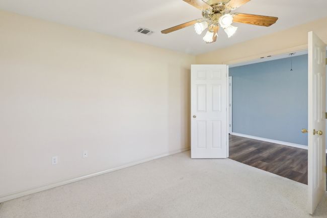 Unfurnished room featuring baseboards, visible vents, carpet flooring, and a ceiling fan | Image 16