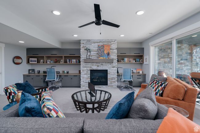 Carpeted living room with ceiling fan, recessed lighting, and a fireplace | Image 31