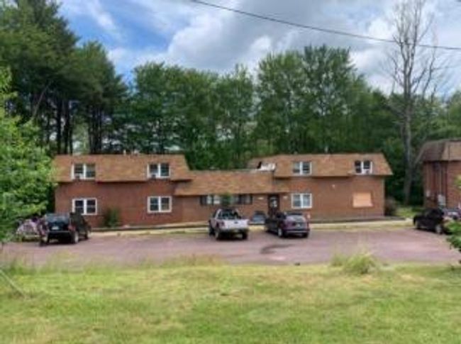 Back of property featuring uncovered parking and a yard | Image 35