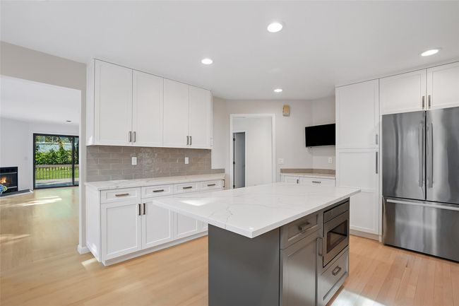 Access to the family room and dining room are foot steps away. Open the doors and drawers to see the custom interiors. | Image 9