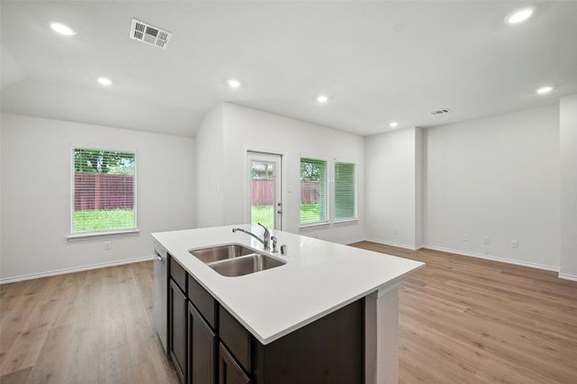 Kitchen with plenty of natural light, light countertops, light wood-style floors, dishwasher, and recessed lighting | Image 8