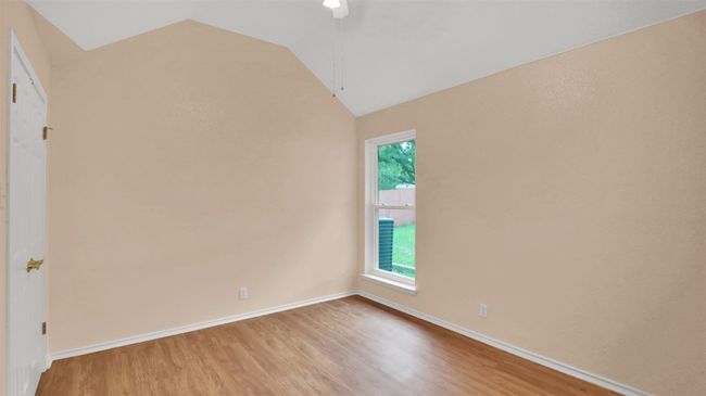 Unfurnished Guest bedroom vinyl plank floors and vaulted ceiling | Image 24