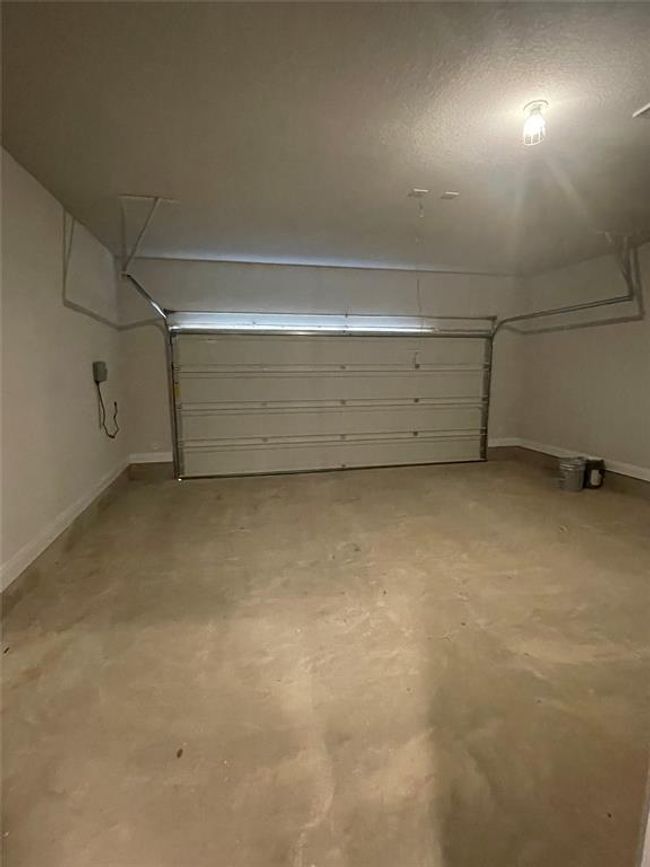 Garage with baseboards | Image 23
