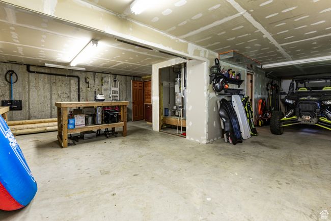 Basement featuring a garage and a workshop area | Image 25