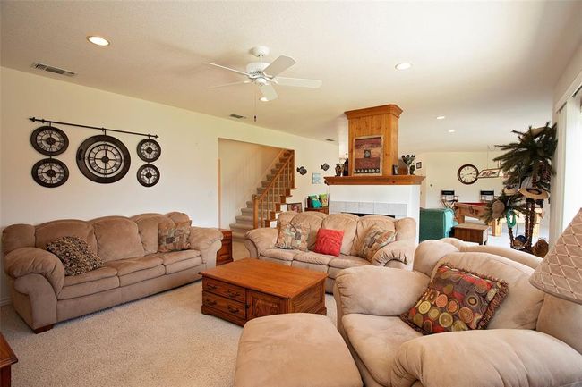 Living room featuring ceiling fan and light carpet | Image 15