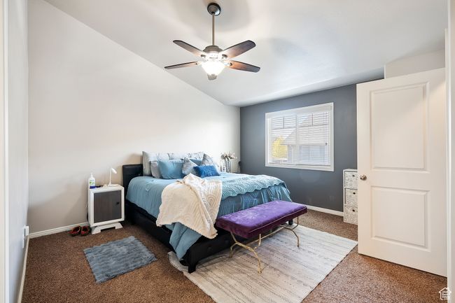 Carpeted bedroom featuring lofted ceiling and a ceiling fan | Image 15
