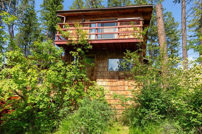 View of property exterior featuring a wooden deck | Image 41