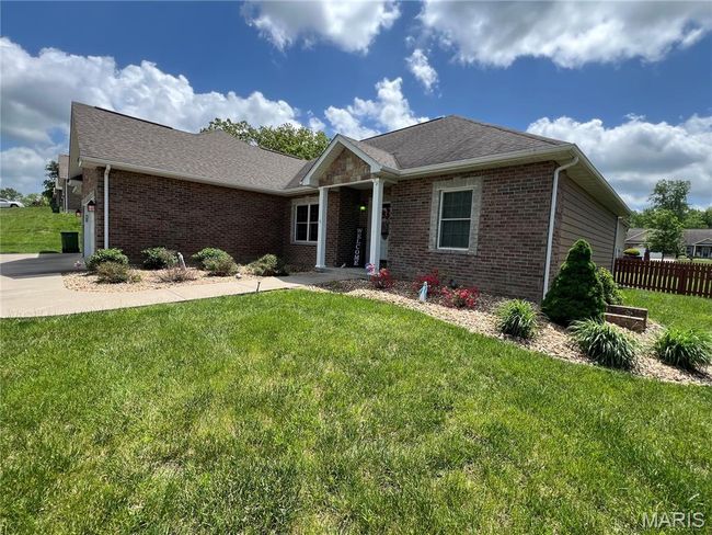 Single story home with brick siding, a garage, and roof with shingles | Image 4