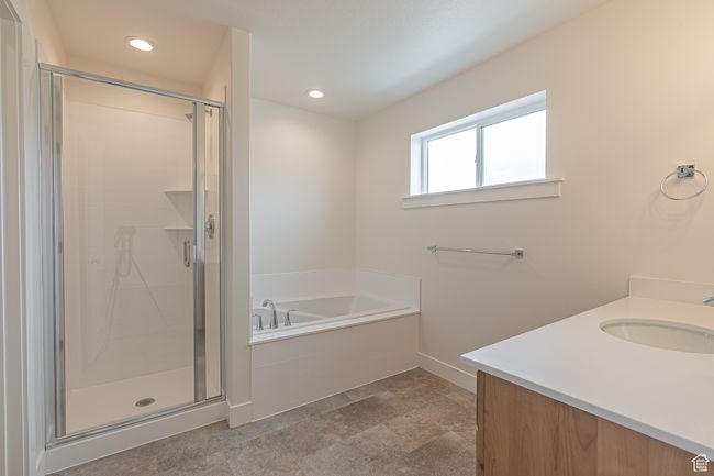 Full bathroom featuring a garden tub, vanity, a shower stall, recessed lighting, and stone finish floors | Image 19