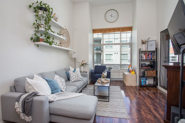 Living room with a high ceiling and dark wood-type flooring | Image 10