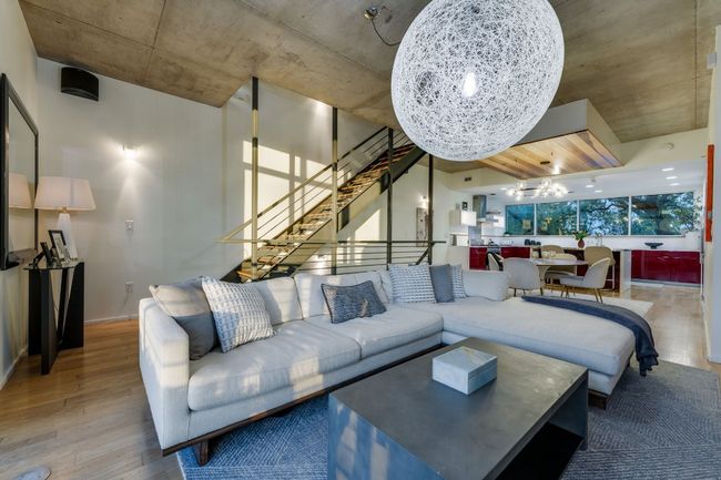 Living room featuring wood-type flooring and a chandelier | Image 7
