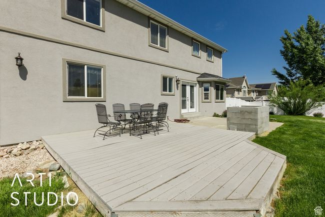 Wooden terrace with french doors, outdoor dining space, and a lawn | Image 38