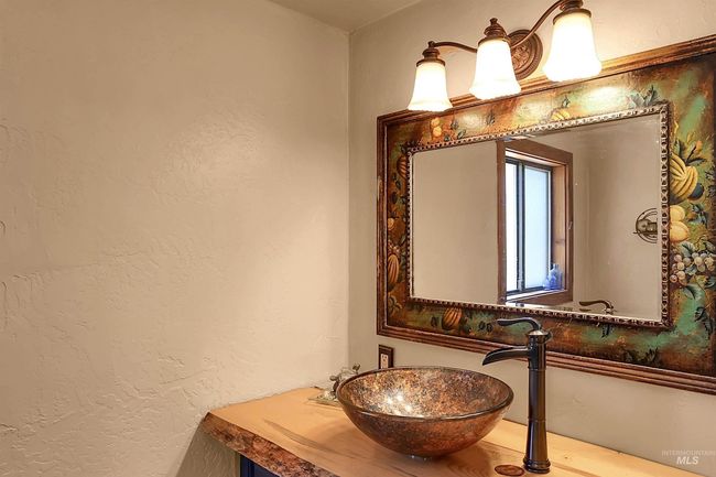 Bathroom with a textured wall and a sink | Image 14
