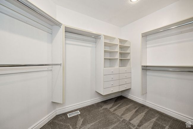 Spacious closet featuring dark carpet | Image 20