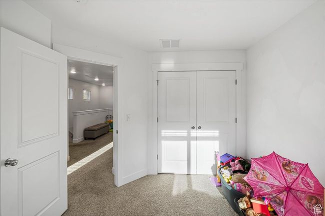 Bedroom featuring carpet, visible vents, baseboards, and a closet | Image 19