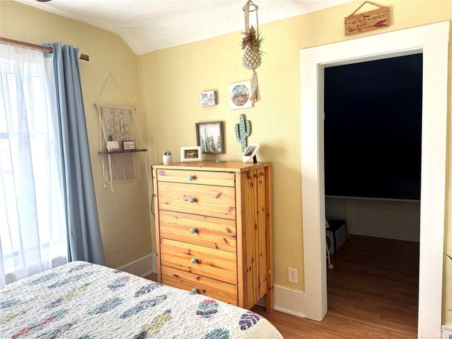 Bedroom featuring wood finished floors and lofted ceiling | Image 26