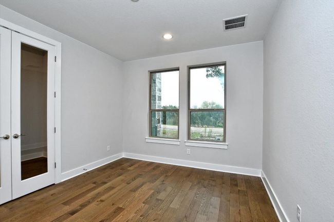 Office/study featuring french doors, hardwood / wood-style flooring, baseboards, visible vents, and recessed lighting | Image 15