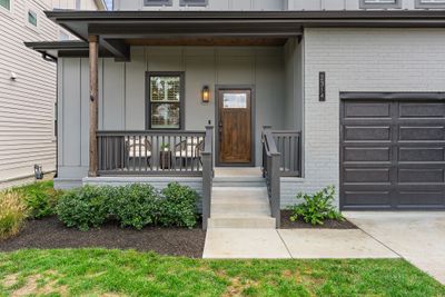 The covered porch is perfect for soaking in the peaceful neighborhood. | Image 2