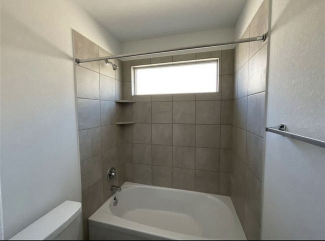 Bathroom featuring toilet and washtub / shower combination | Image 16