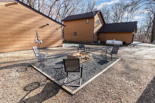 Gather with friends and family around the built-in fire pit. It's a great place to relax, make memories & toast some marshmallows. | Image 34