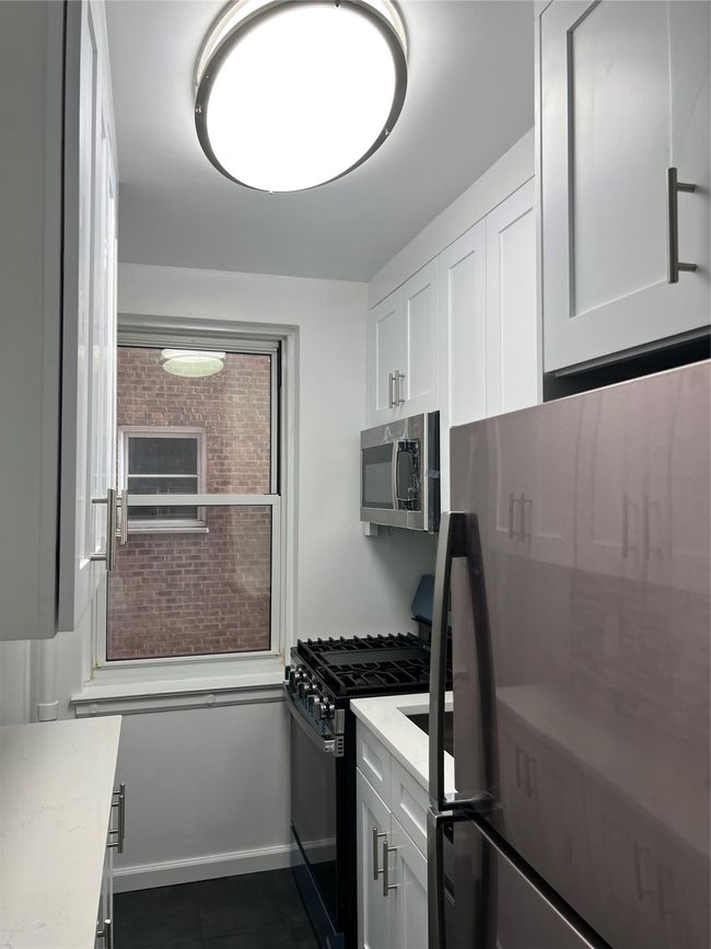 Renovated Full-Kitchen view with stainless - steel appliances | Image 5