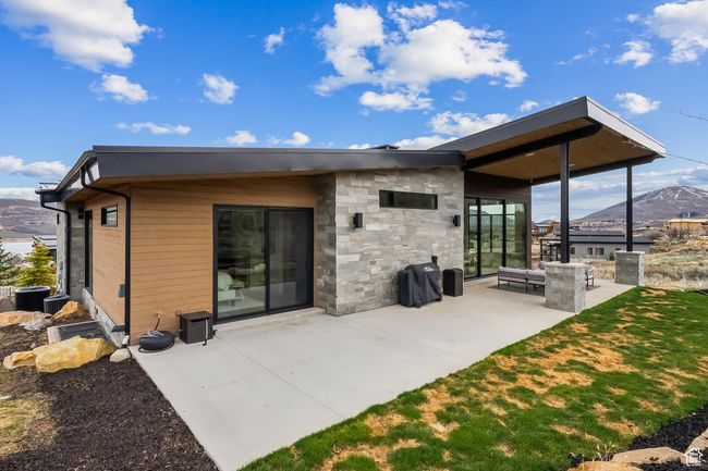 Rear view of house with a mountain view and a patio area | Image 68