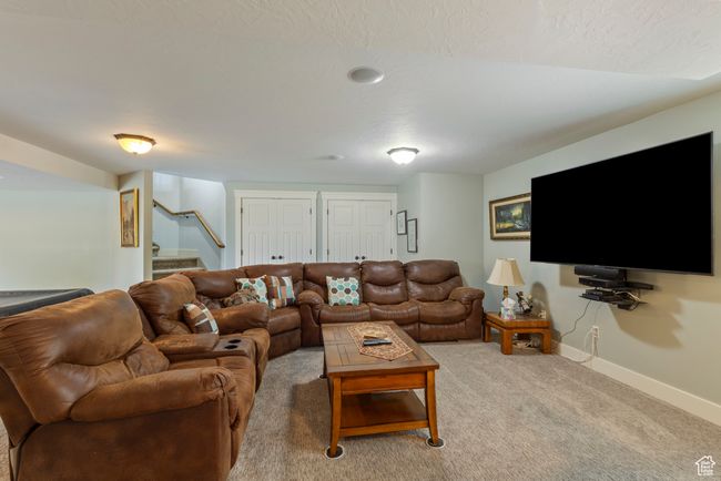 Living room featuring baseboards, stairway, and light carpet | Image 25
