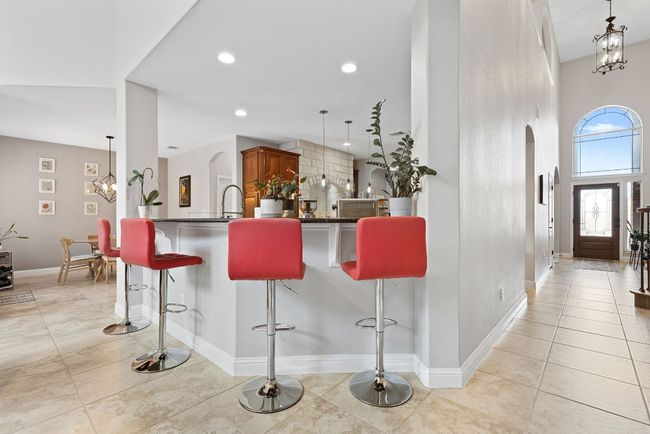 Kitchen bar-top can comfortably seat four. | Image 16