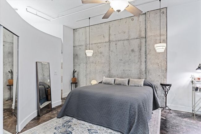 Bedroom with finished concrete floors and ceiling fan | Image 22