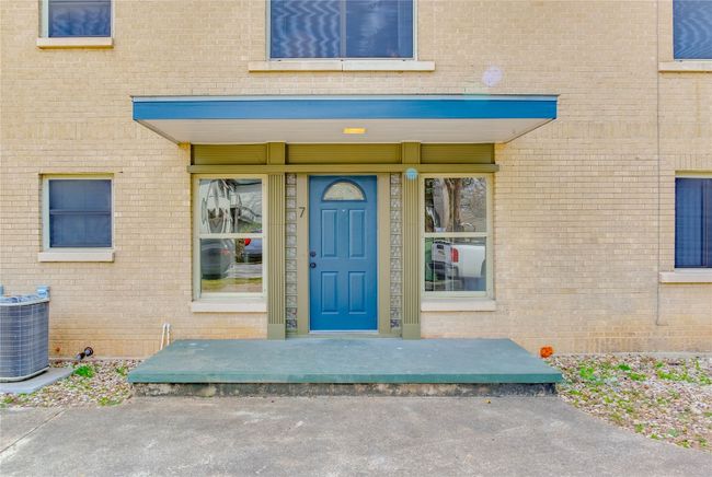 Doorway to property featuring cooling unit and brick siding | Image 35