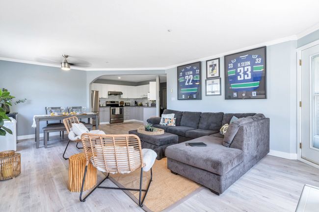 Living area featuring baseboards, crown molding, and light wood-style floors | Image 9