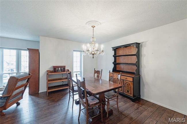 Dining area featuring a chandelier, healthy amount of natural light, and dark wood finished floors | Image 14