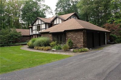 View of side of property featuring a garage and a lawn | Image 2