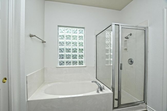 Bathroom with a stall shower and a garden tub | Image 16
