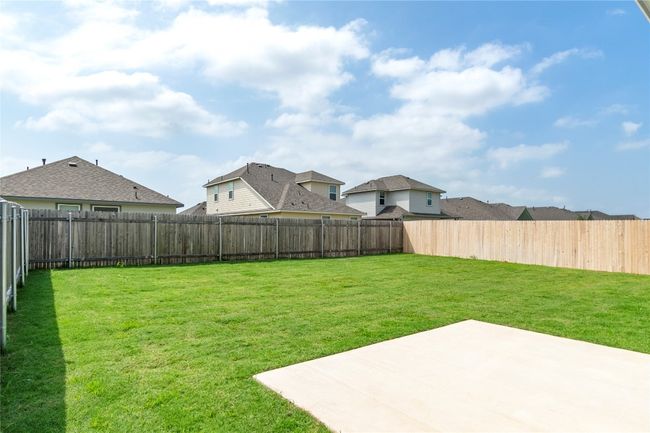 Fenced backyard featuring a patio area and a residential view | Image 29