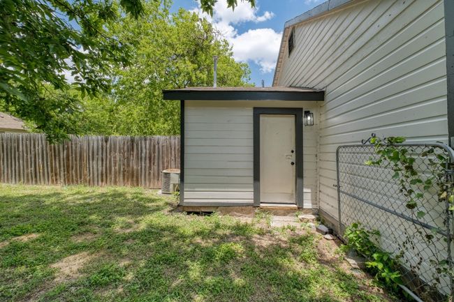 View of outdoor structure with a fenced backyard | Image 21